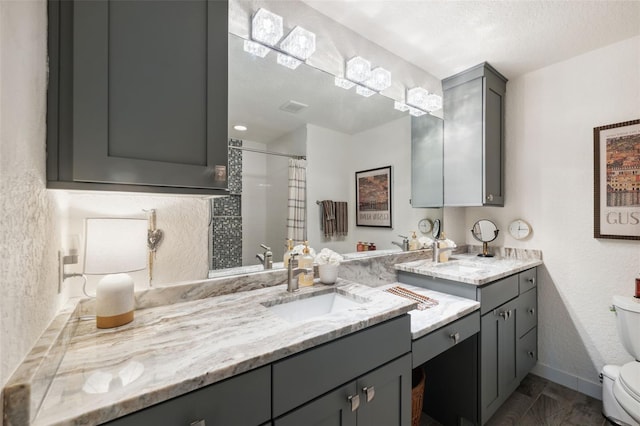 bathroom with vanity, a shower with curtain, a textured ceiling, and toilet