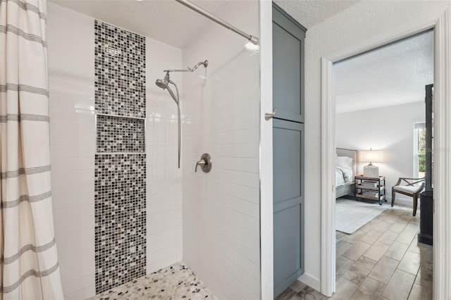 bathroom with curtained shower and a textured ceiling