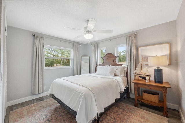 bedroom with dark wood-type flooring and ceiling fan