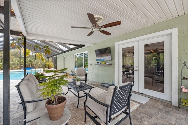 sunroom / solarium with lofted ceiling with beams and french doors