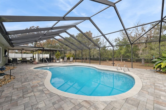 view of pool with a patio area and glass enclosure