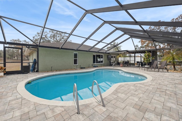 view of swimming pool with a patio area and glass enclosure