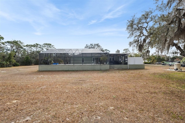 view of yard with glass enclosure