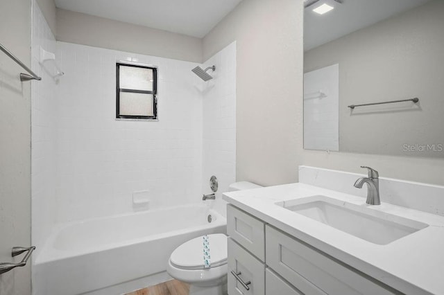 full bathroom with tiled shower / bath, vanity, toilet, and wood-type flooring