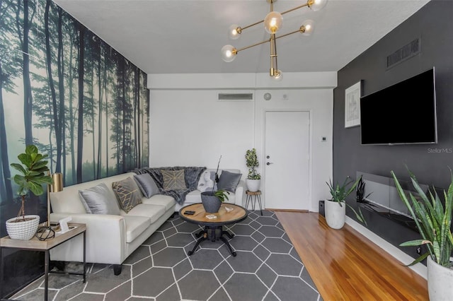 living room with an inviting chandelier and wood-type flooring