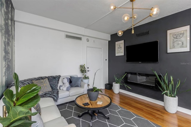 living room with wood-type flooring and a chandelier