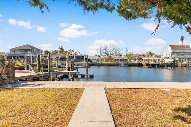 dock area with a water view and a yard