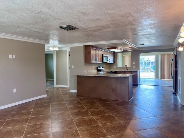 13637 Lagoon Dr, Hudson, FL 34667 - kitchen featuring a peninsula, appliances with stainless steel finishes, ornamental molding, and visible vents