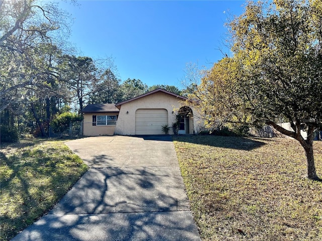 view of front of home with a garage and a front lawn