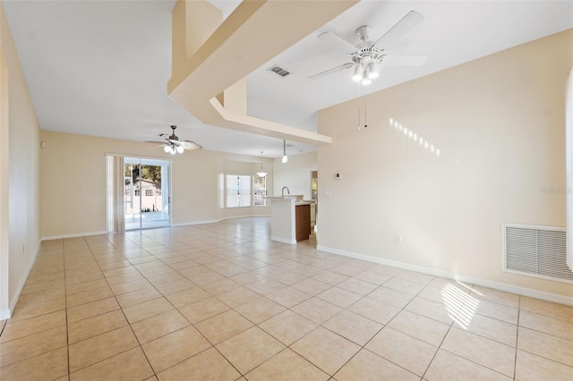 unfurnished living room with light tile patterned flooring and ceiling fan