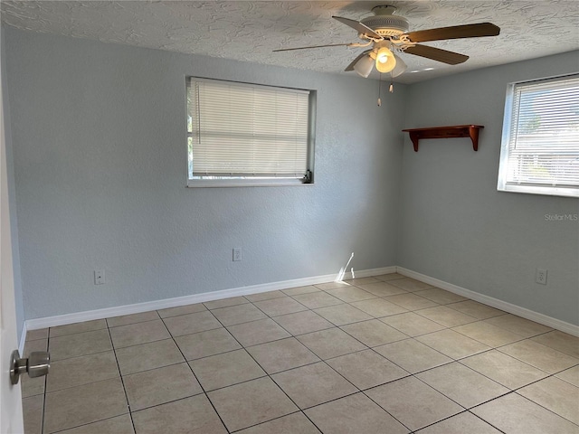 empty room featuring ceiling fan and a textured ceiling