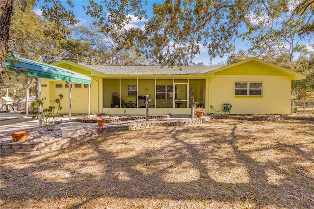 rear view of house with a sunroom