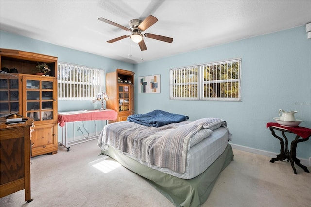 bedroom featuring ceiling fan and light colored carpet