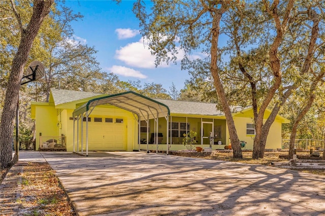 single story home with a carport, a sunroom, and a garage