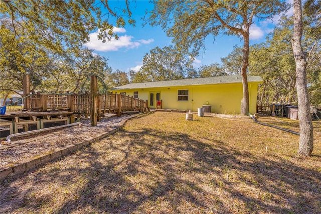 exterior space featuring cooling unit, a yard, french doors, and a deck