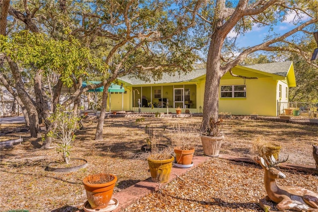 back of house featuring a sunroom