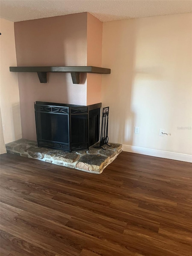 room details with a fireplace, hardwood / wood-style floors, and a textured ceiling