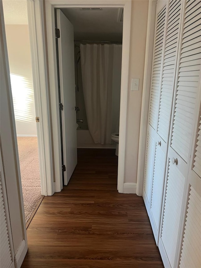 hallway with dark wood-type flooring