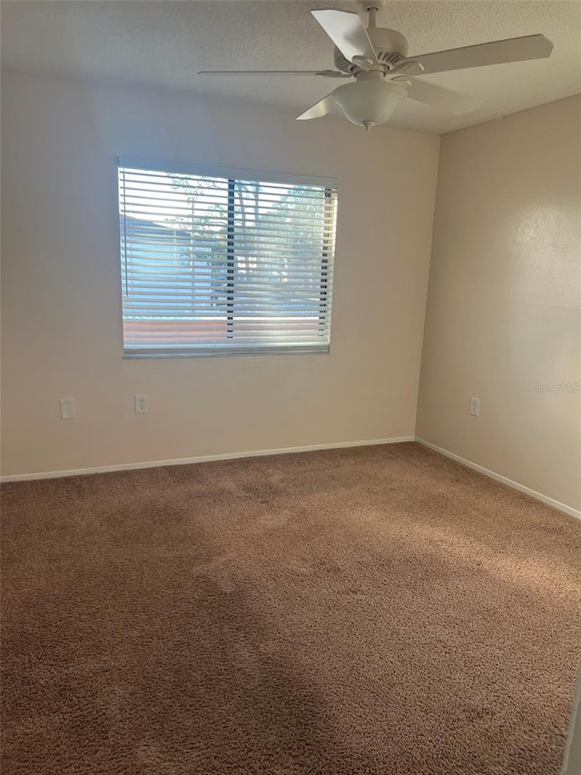 empty room with carpet and ceiling fan