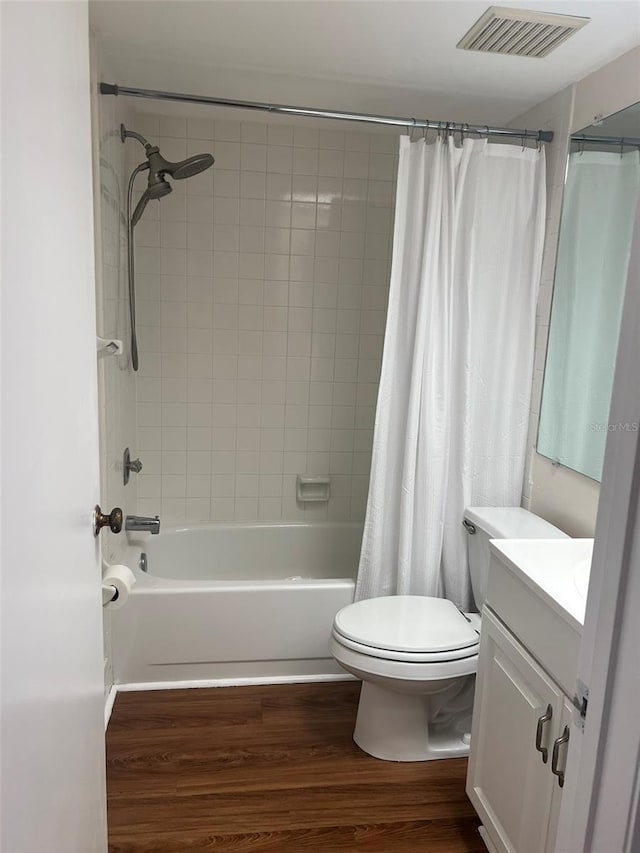 full bathroom featuring vanity, wood-type flooring, toilet, and shower / bathtub combination with curtain