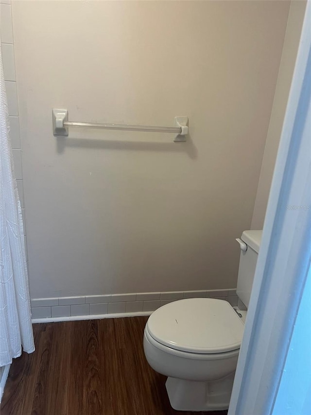 bathroom featuring hardwood / wood-style flooring and toilet