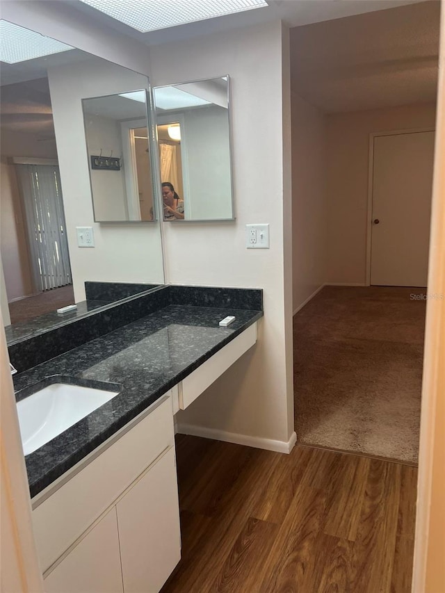 bathroom featuring hardwood / wood-style flooring and vanity