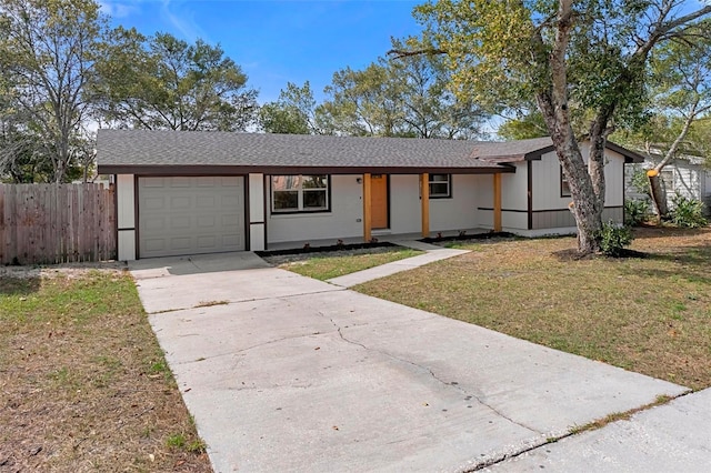 ranch-style house with a front yard and a garage