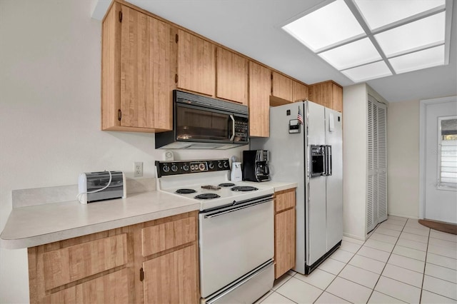 kitchen with light tile patterned flooring and white appliances