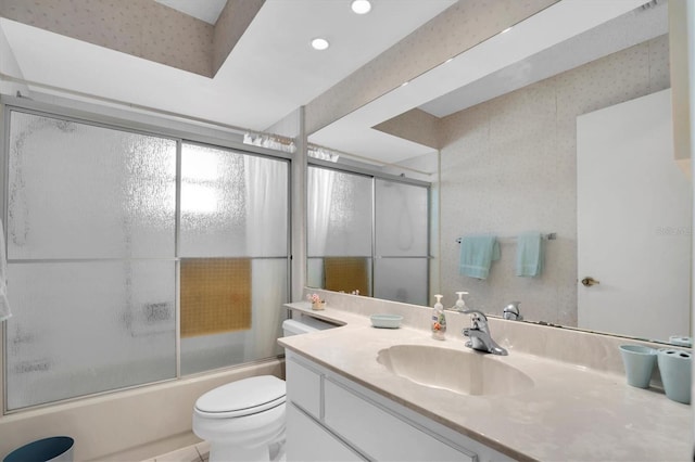 full bathroom with vanity, shower / bath combination with glass door, and toilet