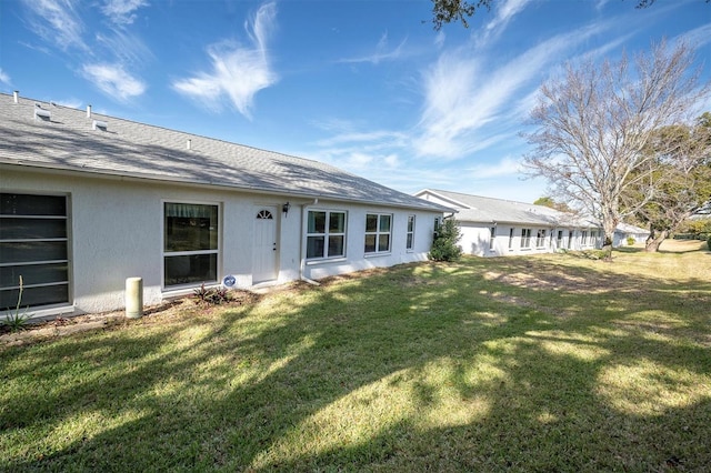 rear view of house with a yard