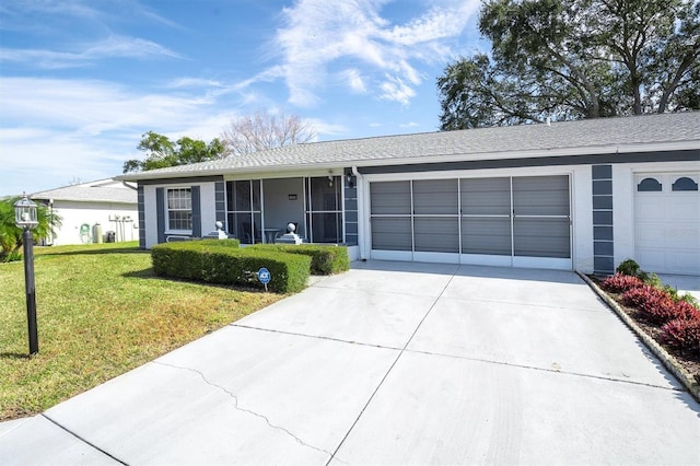 single story home with a garage and a front lawn