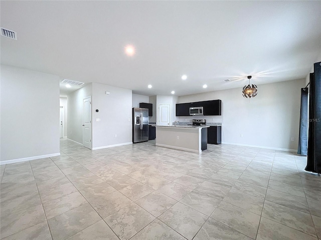 kitchen featuring appliances with stainless steel finishes and a kitchen island with sink