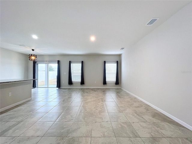 tiled empty room with a healthy amount of sunlight