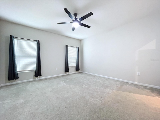 carpeted empty room featuring ceiling fan