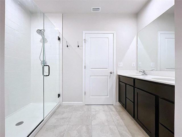 bathroom featuring an enclosed shower and vanity