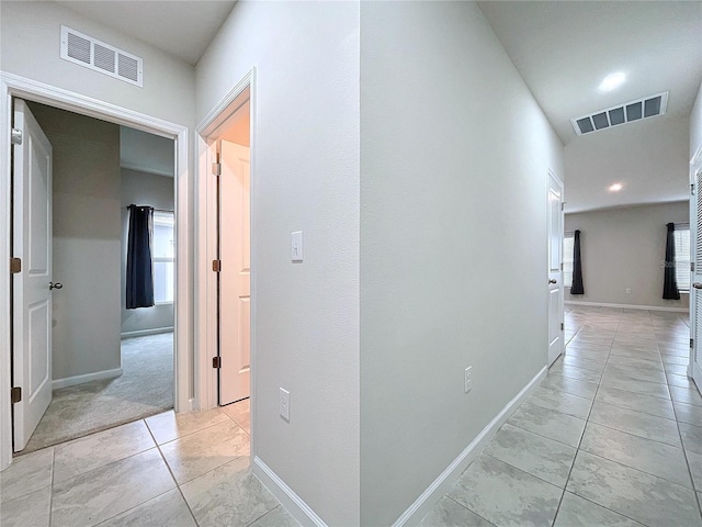 hall featuring light tile patterned floors