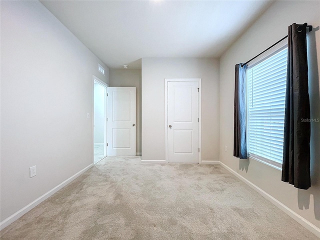 unfurnished bedroom with light colored carpet