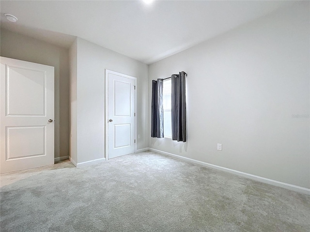 unfurnished bedroom featuring light carpet