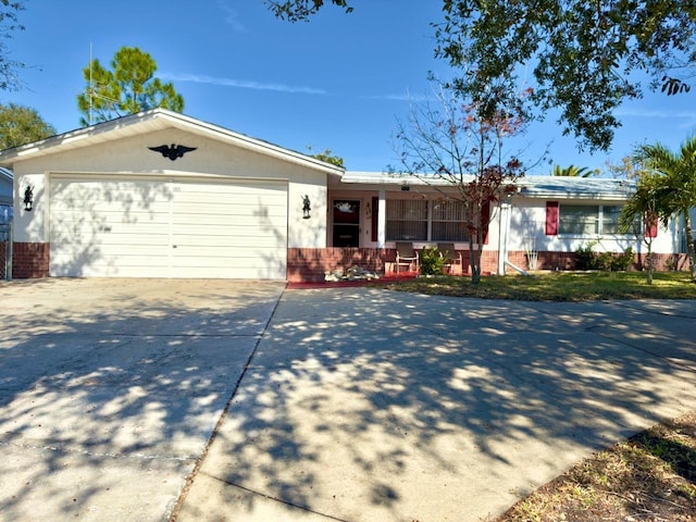 ranch-style house with a garage and covered porch