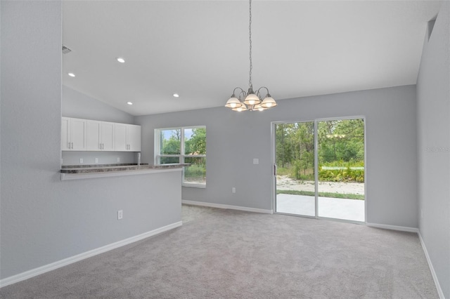 unfurnished living room featuring lofted ceiling, light carpet, and a notable chandelier