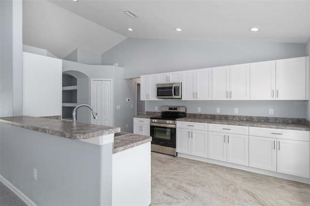 kitchen with sink, high vaulted ceiling, white cabinets, and appliances with stainless steel finishes