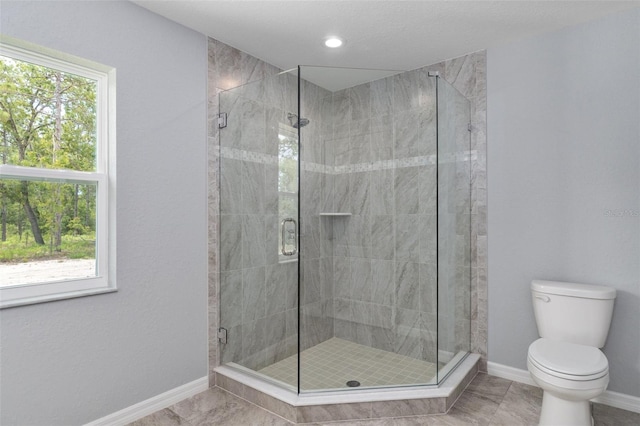 bathroom with toilet, tile patterned floors, and a shower with shower door