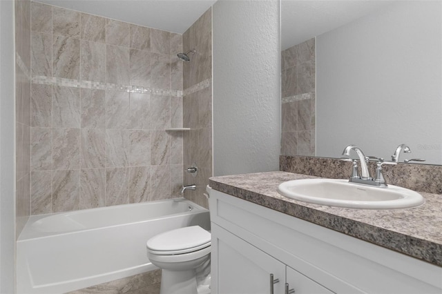 full bathroom featuring vanity, toilet, and tiled shower / bath combo