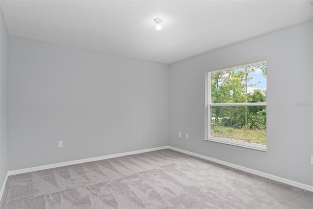 carpeted empty room featuring plenty of natural light