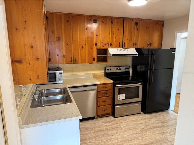 kitchen featuring sink, decorative backsplash, and stainless steel appliances