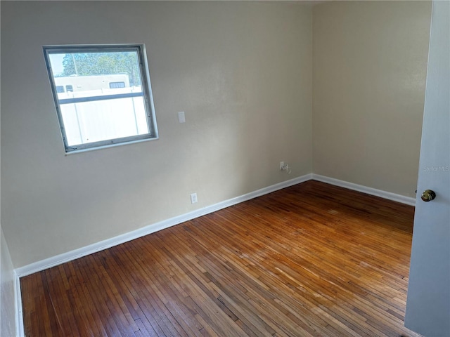 unfurnished room with hardwood / wood-style floors