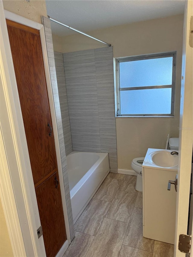 full bathroom with shower / tub combination, vanity, toilet, and tile patterned floors