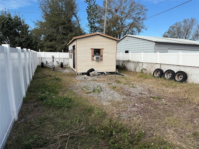 view of home's exterior with cooling unit and an outdoor structure