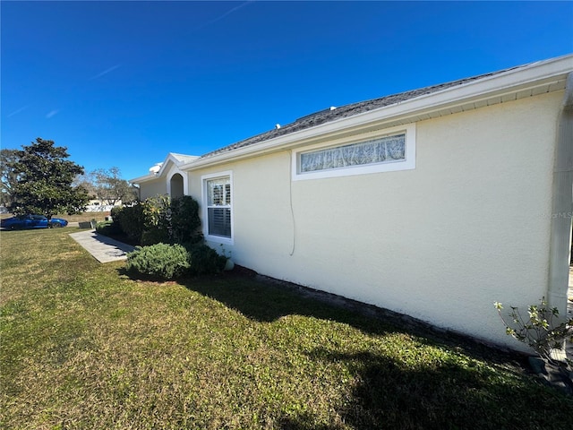 view of side of home featuring a yard