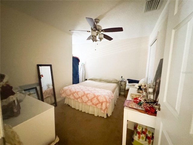 bedroom with ceiling fan and dark colored carpet